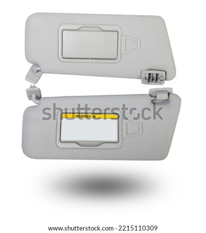 Sun visor with a mirror made of light gray plastic on a white background in a photo studio. Spare part of the car interior for replacement in a car service or for sale on auto dismantling. Royalty-Free Stock Photo #2215110309