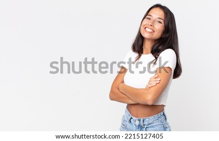 pretty thin hispanic woman laughing happily with arms crossed
