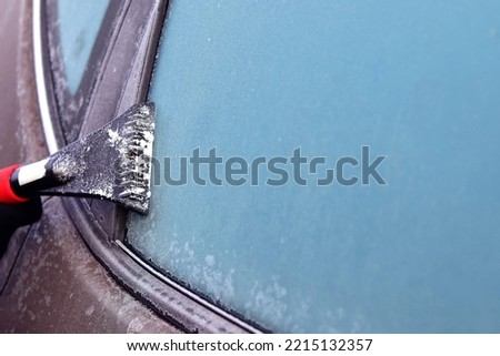 Cleaning snow from windshield, Scraping ice, Winter car window cleaning