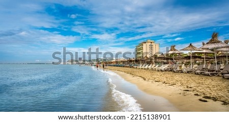 Golem, Durres, ALBANIA. Beach shoreline with sun umbrellas made from straw. A blue sky on the Adriatic Sea. Royalty-Free Stock Photo #2215138901