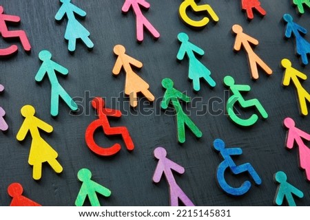 Diversity and inclusion concept. Colorful figurines on the dark surface. Royalty-Free Stock Photo #2215145831