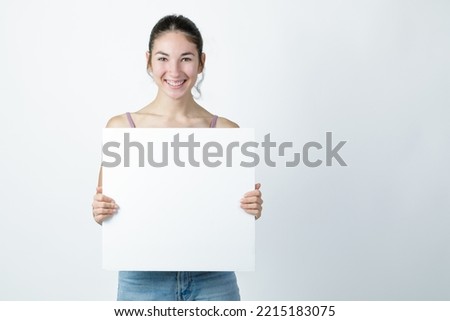Young woman holding a blank white sign - Banner Mockup.