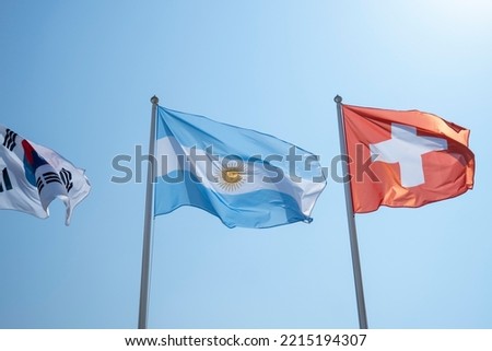 The national flag of the Argentine Republic is a triband, composed of three equally wide horizontal bands coloured light blue and white. Royalty-Free Stock Photo #2215194307