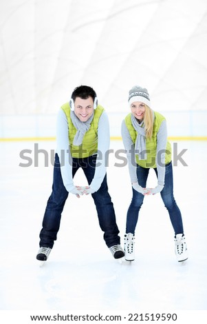 A picture of a happy woman on the ice rink