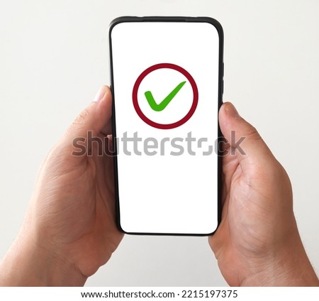 Smartphone with green checkmark to indicate an approved status.