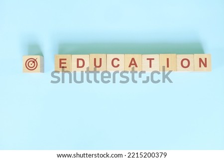 Demographics education or educational level  targeting for business marketing and advertising concept. Word typography flat lay in blue background. Royalty-Free Stock Photo #2215200379