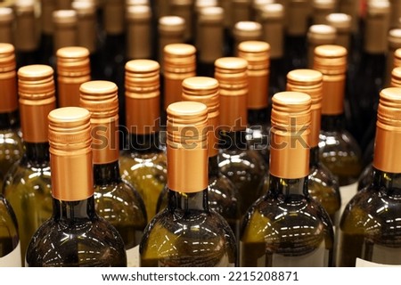 Wine bottles in a row, selective focus. Liquor store, white wine production concept