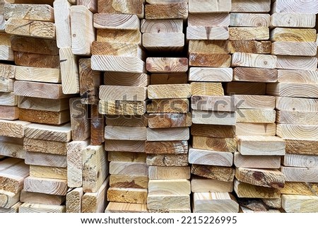 Many wooden boards are stacked. Lumber for construction