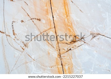 Texture of sandstone with many cracks, orange and white