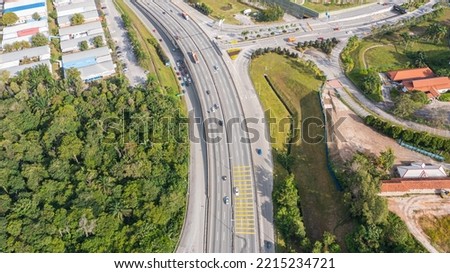 Aerial view directly above a six lane highway. Top view of asphalt road passes through the field and forest. Aerial. Sedan cars driving by the highway. Top view from drone. aerial photo autobahn road Royalty-Free Stock Photo #2215234721