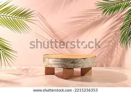 Wooden birch saw cut on an empty premium podium with shadows of tropical leaves, Minimal abstract background for the presentation of cosmetic products. eco template for design, podium pedestal