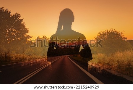 Finding your inner peace, getting away from it all, and free your mind concept. Thoughtful woman facing empty country road.  Royalty-Free Stock Photo #2215240929