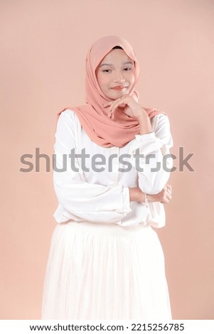 Beautiful asian women in hijab over isolated background. Smiling young asian muslim woman.
