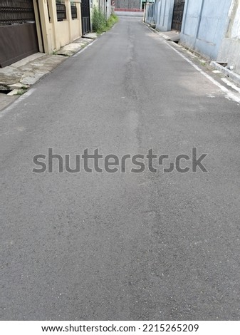 asphalt road in the middle of the village