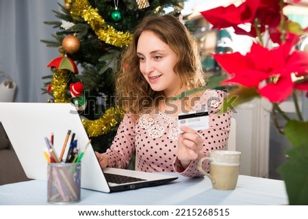 Young woman makes online shopping with credit card and laptop. High quality photo