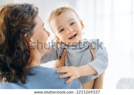 Love of mother and baby. Happy family in the bedroom at home.