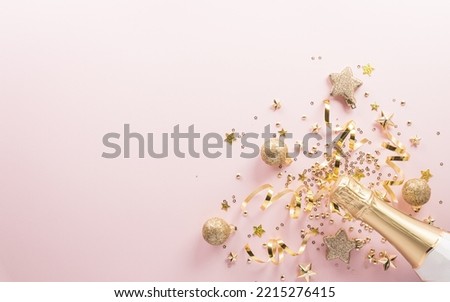 Happy New year celebration background concept. Champagne bottle , golden ribbon, stars and christmas ball on pastel background.