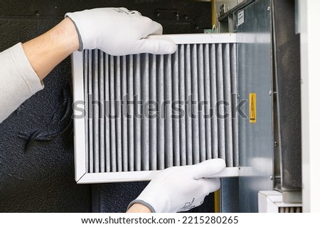hvac filter replacing. Replacing the filter in the central ventilation system, furnace. Replacing Dirty Air filter for home central air conditioning system. Change filter in rotary heat exchanger Royalty-Free Stock Photo #2215280265