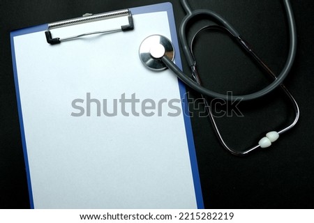 Doctors Work Desk In Hospital With Notepad, medical stethoscope, many colored pills, capsules, concept of maintaining health, medication treatment, vitamins, dietary supplements, top view