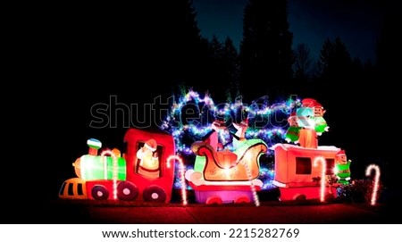 Christmas inflatable street decorations at night. Christmas and New Year background.