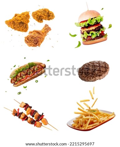 flying fast food dishes isolated on white abstract background. floating burger, steak, French fries, chicken sticks, fried chicken, hot dog. abstract fast food mock up and template design. Royalty-Free Stock Photo #2215295697