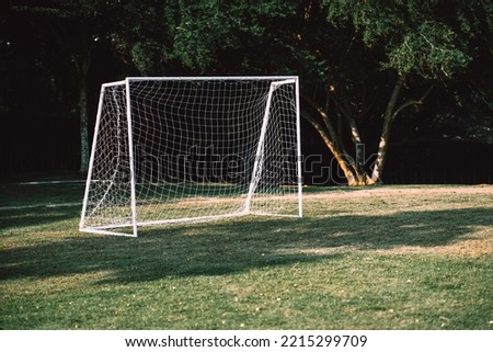 Football goal put on the grass field without people in the park. A mini net goal at playground for small groups people can have exercise activities and leisure.
