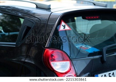 Ukrainian driving school sign on car window. mark on the rear window of a car designation of an inexperienced driver behind the wheel, a warning signal. Royalty-Free Stock Photo #2215303861
