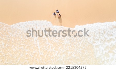 Aerial view of a tropical coast with mother and kids enjoying beach vacation in Phuket Thailand.white sand beach aerial sea view with mother children kids.landscape people.water ocean day.experience.