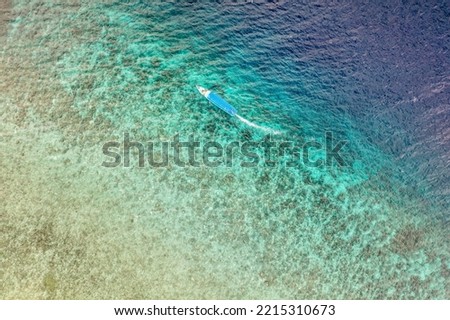 View of coral lagoon and small fisherman boat near Gili Meno -small tropical island in West Nusa Tenggara, Indonesia