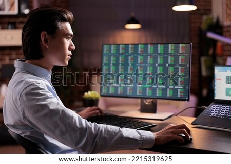 Male worker analyzing stock market trade on computer, working with web 3.0 hypertext on laptop. Looking at real time global investment and capital money profit exchange, doing financial remote job.