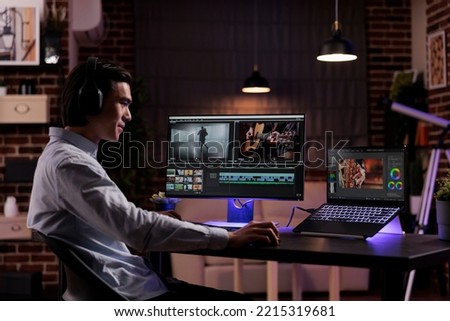 Film maker working on video production, editing multimedia montage and movie footage to create agency content. Using software on computer to edit professional film with color grading effects. Royalty-Free Stock Photo #2215319681