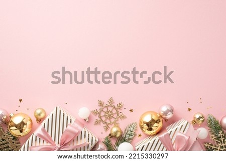 New Year concept. Top view photo of big present boxes with ribbon bows pine branches in frost gold white pink baubles snowflake ornament and confetti on isolated light pink background with empty space