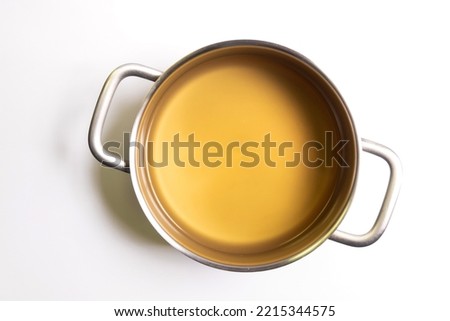 Pot of chicken broth isolated on white background. Top view.