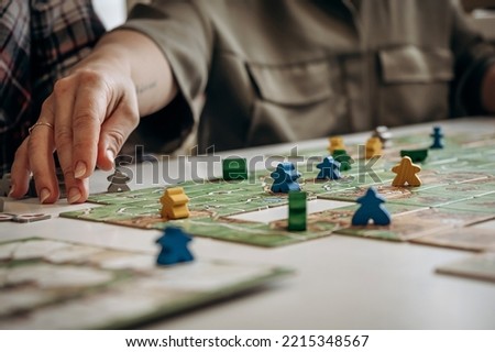 Close-up of women's hand playing board games.Board games concept.Selective focus.