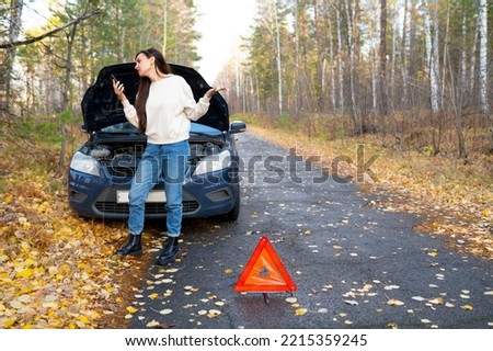 woman car breakdown. the woman calls the emergency services. car breakdown call by phone