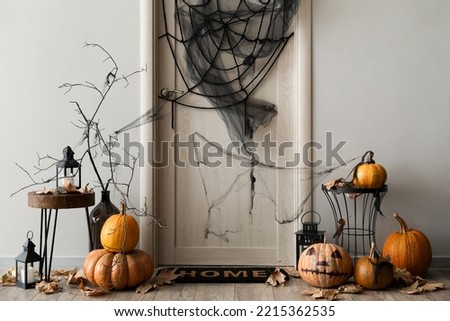 Interior of light hall decorated for Halloween with door and tables
