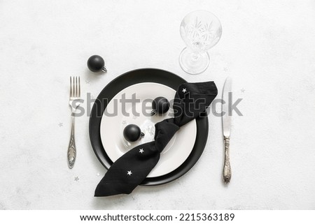 Beautiful table setting with Christmas decorations on light background