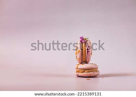 French or Italian macarons with coffee and vanilla filling, pink background. Dessert for tea or coffee break. Food background. Pastel color.