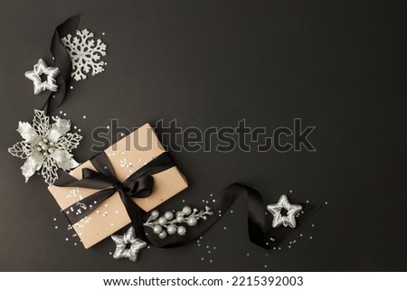 Christmas gifts, presents, ornaments on black holiday background. Merry Christmas luxury stylish greeting card, frame. Winter xmas holiday theme. Happy New Year 2022, copy space, banner, flyer