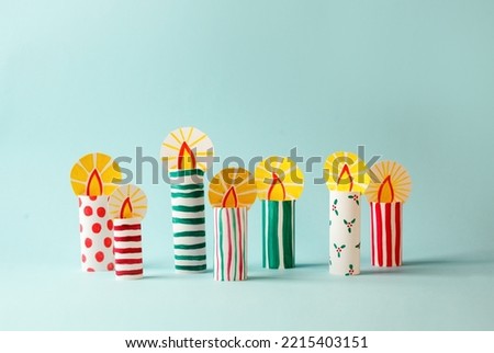 The child DIY for Jewish holiday of Hanukkah. Traditional candlestick 7 candles from toilet tube, recycle concept. Children's Art Project, needlework, crafts for children.