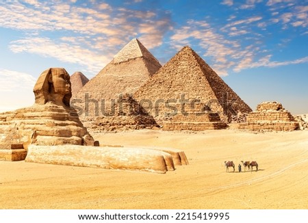 The Great Sphinx next to the Pyramids of Egypt in the desert of Giza Royalty-Free Stock Photo #2215419995