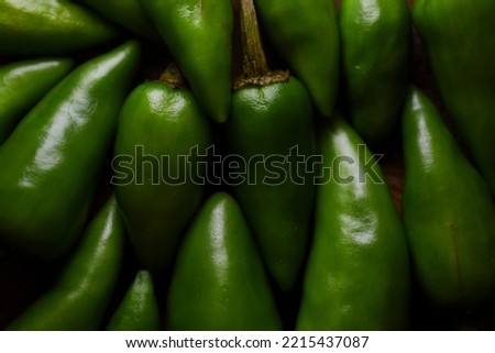 View of green chillies on wooden tray