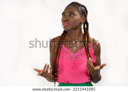 The woman who feels confused cannot understand what her friend is referring to. Portrait of dark skinned woman clueless and questioned unaware Royalty-Free Stock Photo #2215441085