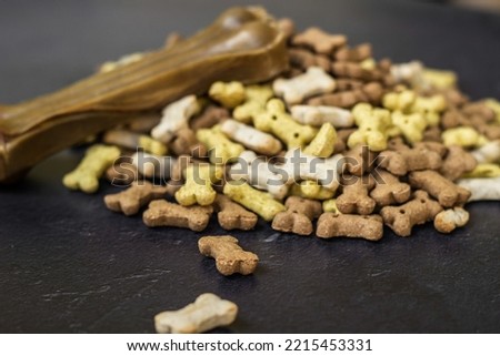 Chewing bones on black wooden background, sweet snack