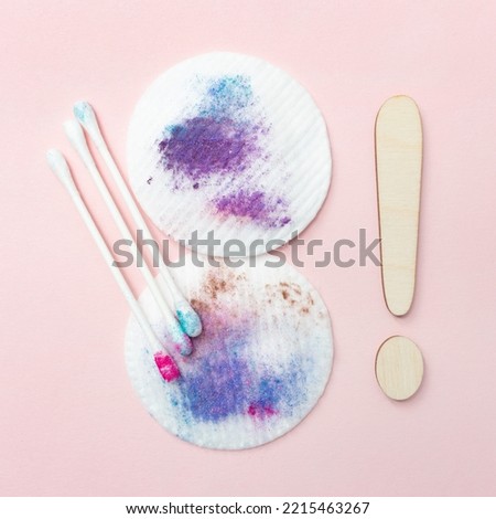 Dirty cotton pads and sticks after removing makeup. Square. Pink background. Dirty cosmetic pad after removing make-up. Hygiene concept. Exclamation point. Royalty-Free Stock Photo #2215463267