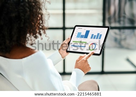 business woman analyzing a graph on the screen of a digital tablet. Royalty-Free Stock Photo #2215465881