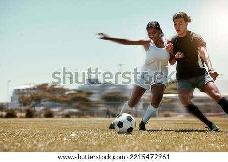 Sport, friends and soccer with man and woman playing on a soccer field, competitive training for sports goal. Fitness, couple and energy with interracial guy and lady having fun with outdoor football
