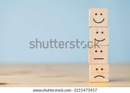 Satisfaction survey concept. Wooden cube block stacking with face symbol. The best excellent business services rating customer experience Royalty-Free Stock Photo #2215473457