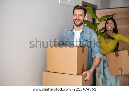 Happy young couple with cardboard boxes in their new home. Royalty-Free Stock Photo #2215474961