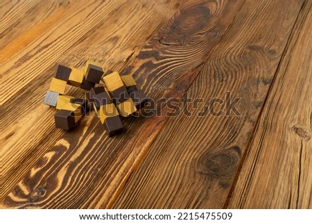Wood puzzle, brain teaser closeup. Wooden game block, brainteaser, logic game, mechanical puzzles, logic 3d toy, wood puzzle with selective focus